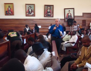 Steven Youngblood addresses journalists in Kampala