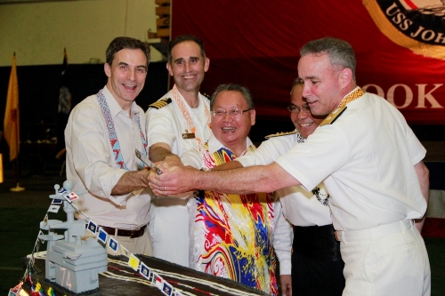 Ambassador Paul W. Jones, RDML Gaouette, Capt. Reis and Tan Sri Joseph Pairin Kitingan cutting a cake that resembles the aircraft carrier USS Stennis. This visit marks the first time a U.S. Navy aircraft carrier has visited Sabah. (U.S. Embassy photo)