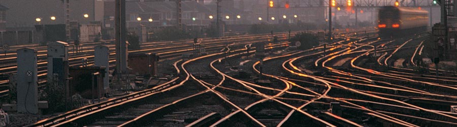 Many intersecting rails and a moving train