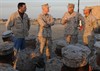 CAMP PATRIOT, Kuwait (December 22, 2009) - Col. Benjamin Braden, Commander, Marine Corps Logistics Command Forward, recognizes successes of Cpl. Sean Rodriguez, Marine Corps Logistics Command, to General James F. Amos (Standing second from left), Assistant Commandant of the Marine Corps, and Darrell Issa (Standing left), Congressman for the 49th Congressional District, during a Dec. 22 visit to Camp Patriot, Kuwait. The Marines sustain operations involving the movement of equipment from Iraq back to the United States. The general used the opportunity to express his appreciation for their service. “All I can say is I am proud of them,” said Amos. “Every one of them signed up and they didn’t have to. I want to wish them all a Merry Christmas and a happy new year.”
