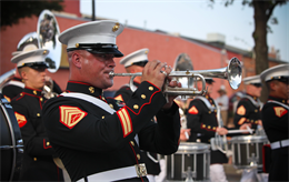 Staff Sgt. Steven Williams, a trumpet player with the 2nd Marine Division Band, plays the trumpet as the Band marches through downtown’s main street.  Williams will be taking on the challenge of leading the Marine musicians as the assistant drum major for The President’s Own.  