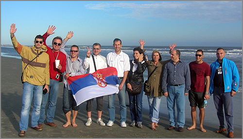 A group of people posing on a beach