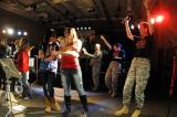 Staff Sgt. Lynne Krug claps as members of the audience join her on stage at Lisbon High School as she performs with the 188th Army Band's Three Time Rule, a rock and country ensemble, during the 2013 Music in Schools Tour. 