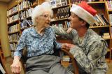 Staff Sgt. Amy Wieser Willson, ND National Guard, gives an affectionate embrace to Lisbon, N.D., Veterans Home resident and World War II veteran Capt. Elizabeth “Betty” Frye-Graham Dec. 19 during an annual Veterans Appreciation Day event at the home.