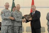 ND Gov. Jack Dalrymple, presents an Air Force Outstanding Unit Award plaque to Col. Rick Gibney, the 119th Wing commander, as Maj. Gen. David A. Sprynczynatyk, ND adjutant general, looks on. This is the 14th such award the wing has received.