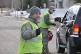 Tech. Sgt. Eric Hoff and Master Sgt. Erik Clemenson direct traffic at a control point for flood-fighting material in Fargo. 