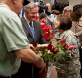 Sgt. 1st Class Diane Wald shakes Gov. Jack Dalrymple's hand as flowers were handed out to all female Veterans attending the proclamation signing declaring March as Women Veterans Month.