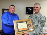 Maj. Gen. David Sprynczynatyk, North Dakota adjutant general, presents a plaque to Keith Pagel, the Fargo Division Manager of Cass-Clay Creamery Inc. in recognition of Cass-Clay’s contribution to the North Dakota National Guard.