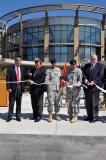 From left to right, Gov. John Hoeven, Congressman Earl Pomeroy, Maj. Gen. David Sprynczynatyk, Col. Steve Tabor, and Mr. Jim Hand, cut a ceremonial ribbon as they celebrate the completion of the 164th Regiment Regional Training Institute.
