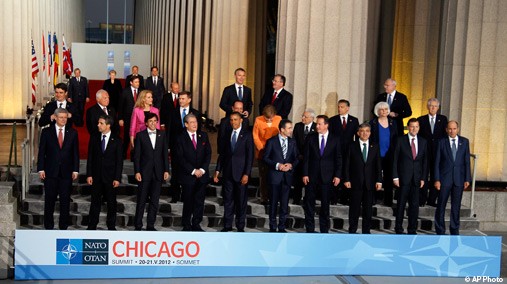 The NATO leaders gather for a group picture upon their arrival for dinner at Soldier Field in Chicago, May 20, 2012. Front row from left are Canadian Prime Minister Stephen Harper, Bulgarian President Rosen Plevneliev, Belgium Prime Minister Elio Di Rupo, Albanian Prime Minister Sali Berisha, President Barack Obama, NATO Secretary General Anders Fogh Rasmussen, British Prime Minister David Cameron, Turkish President Abdullah Gul, Spanish Prime Minister Mariano Rajoy and Slovenian Prime Minister Janez Jansa. Second row from left are Croatian President Ivo Josipovic, Czech Republic President Vaclav Klaus, Danish Prime Minister Helle Thorning-Schmidt, Estonian President Toomas Hendrik Ilves, French President Francois Hollande, German Chancellor Angela Merkel, Greek Foreign Minister Petros Molyviatis, Hungarian Prime Minister Viktor Orban, Iceland's Prime Minister Johanna Siguroardottir, and Italian Prime Minister Mario Monti. Back row from left are Luxembourg Prime Minister Jean-Claude Juncker, Lithuanian President Dalia Grybauskaite, Portuguese Prime Minister Pedro Passos Coelho, Latvian President Andris Berzins, Netherlands Prime Minister Mark Rutte, Romanian President Traian Basescu, Norwegian Prime Minister Jens Stoltenberg, Polish President Bronislaw Komorowski, and Slovakian President Ivan Gasparovic. [AP Photo]