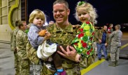 Air Force Maj. Andrew Cunnar, a navigator assigned to the 15th Special Operations Squadron, holds his children in his arms at Operation Homecoming on Hurlburt Field, Fla., Jan. 8. 2012. Operation Homecoming is a program created to welcome home airmen returning from recent deployments. U.S. Air Force photo by Airman 1st Class Nigel Sandridge