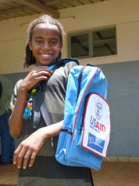 Girl wearing a USAID backpack