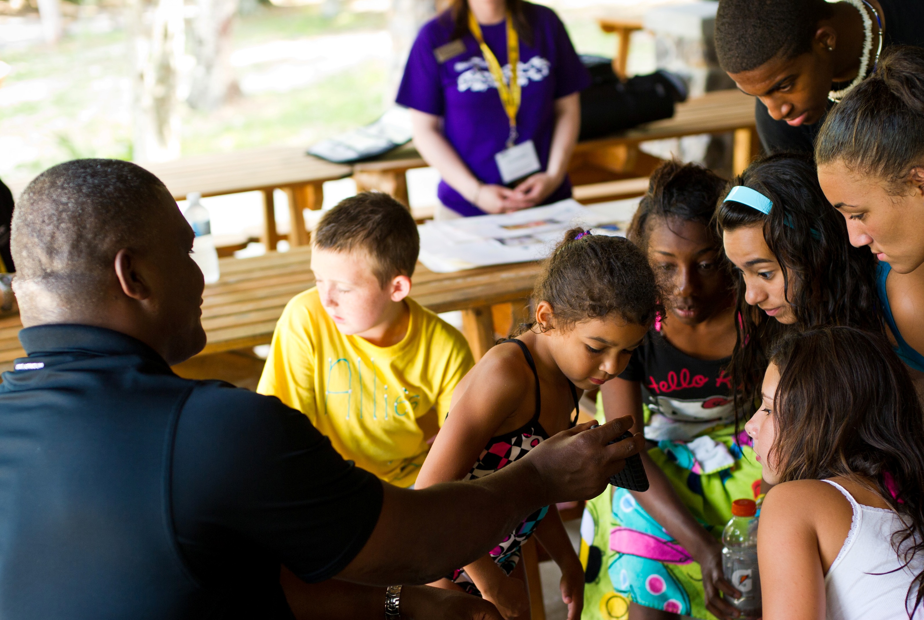 AW2 Director COL Gregory D. Gadson shows photos from the explosion that injured him during deployment in Iraq to children attending Operation Purple® camp.