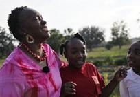 St. Helena Island farmer Sara Reynolds enjoys a laugh with her young volunteer.