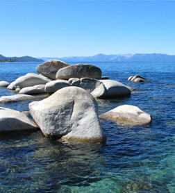 Photo of boulders in the blue green mountain waters of Lake Tahoe,Nevada.