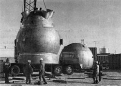 The 15 foot bubble chamber arrives "home" after a temporary stop in The Village, following its arrival on October 25. Hemisphere on the ground is the upper portion of the vacuum tank which surrounds the chamber