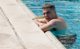 MARINE CORPS BASE HAWAII - Sgt. Daniel Brown, a radio operator with 3rd Marine Regiment, pauses after swimming laps at the base pool, Feb. 6, 2013. Brown is competing in the Semper Fit Center’s Try-Athlon this month, swimming 2.4 miles, biking 112 miles and running 26.2 miles at his own pace — the equivalent of an Ironman triathlon — during the month of February. (U.S. Marine Corps photo by Kristen Wong)