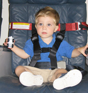 young boy in child harness restraint