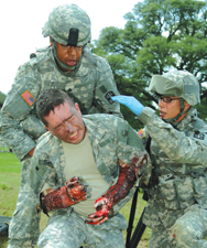 SGT Stephen Turner and PFC Nicholas Stoup simulate burn injury transport during exercise.