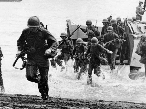 U.S. Marines from New Zealand storm ashore at Guadalcanal in the first Allied counter-offensive of the Pacific war. More than 7,000 Marines died there.