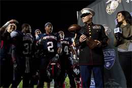 Sgt. Maj. Micheal Barrett, Sergeant Major of the Marine Corps, presents the Semper Fidelis All-American Bowl trophy to the East Coast team for their 17-14 win against the West on Jan. 4, 2013. The Semper Fidelis Bowl is unique because it brings together some of the nations top high school student athletes who excel not only on the field but in the classroom and in their communities as well.