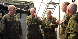 Cmdr. Joe T. Patterson, right, explains how 3rd Medical Battalion aids III Marine Expeditionary Force with its mission to, from left, Rear Adm. Michael H. Anderson, Rear Adm. Charles Harr and Navy Capt. John P. LaBanc, Jan. 15 at Camp Foster. The battalion designed III MEF’s first medical predeployment training facility, according to Lt. Eva Reed, the officer in charge of the battalion’s simulated trauma and advanced training center. Patterson is the commanding officer of the battalion, which is part of Combat Logistics Regiment 35, 3rd Marine Logistics Group, III Marine Expeditionary Force. Anderson is the medical officer of the Marine Corps, Harr is the deputy medical officer of the Marine Corps, and LaBanc is the III MEF surgeon. 