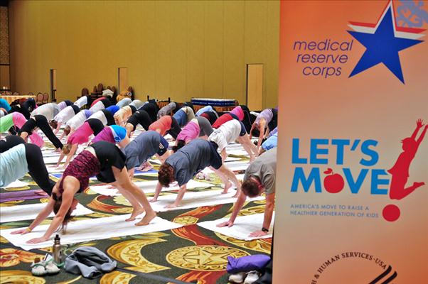 Attendees doing yoga exercises during session.