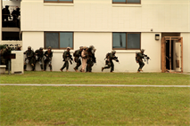 Marines and Sailors from the Maritime Raid Force of the 31st Marine Expeditionary Unit rush to an entryway after breaching it with explosives during a time sensitive raid here, Jan 7. The MRF is comprised of a security element from Battalion Landing Team 1st Battalion, 5th Marine Regiment, e Force Reconnaissance Platoon, and the Amphibious Reconnaissance Platoon, 31st MEU. The 31st MEU is the only continuously forward-deployed MEU and is the Marine Corps’ force in readiness in the Asia-Pacific region.