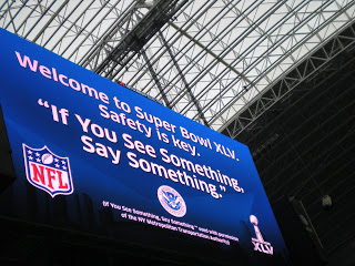 'If You See Something, Say Something ™' appears on the octagonal 'jumbotron' at Cowboys Stadium. Photo courtesy of: DHS