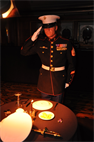 Staff Sergeant Nicholas Beberniss, a range coach, armorer, and Purple Heart recipient, aboard Marine Corps Logistics Base Barstow salutes a lone table, set up in honor of fallen heroes, while Taps...

