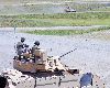 Members of a Bradley Fighting Vehicle crew with the 1st Bn., 18th Inf. Regt. watch as another crew moves down a qualification lane during a gunnery exercise July 25 at Fort Riley’s Douthit Range Complex.  Photo by: Mollie Miller, 1ST INF. DIV.