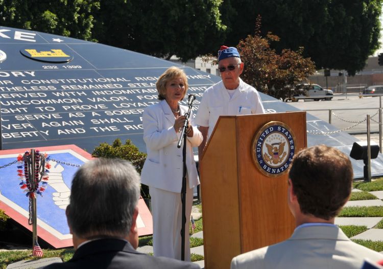 Sam Fujikawa, 100th Infantry Battalion, presents his unit medallion to Senator Boxer.