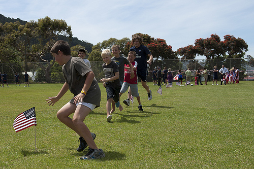 The children having a fun rugby drill at the picnic.