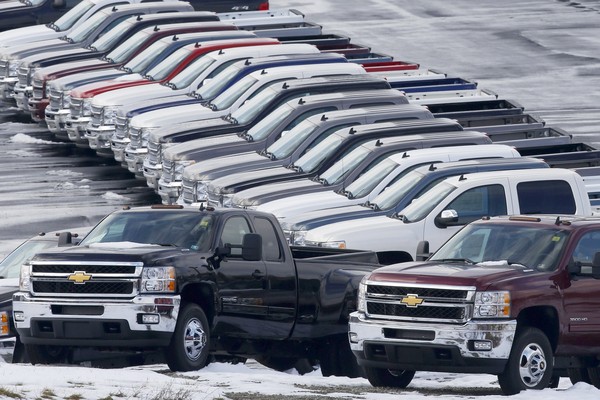 Chevy trucks line the lot of a dealer in Murrysville, Pa. GM said its fourth-quarter profit grew 89% to $892 million from the same period a year earlier.