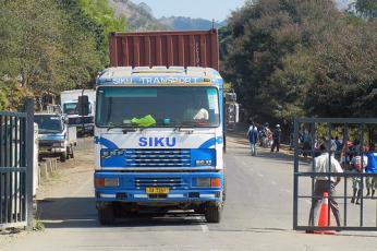 A large truck pulls up to a border crossing