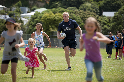 Eagles player, Mark Bokhoven, having a running race with the children at the picnic.