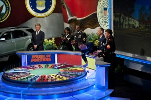 Greg takes his first spin on the "Wheel of Fortune" game show while Glenn prepares to take a guess on the puzzle's letters.