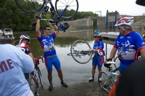 Members of the RAGBRAI Air Force Cycle Team dip their tires into the Mississippi River to signify the end of the ride in Clinton, Iowa.