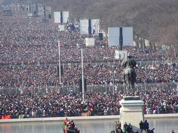 Crowds amid jumbo TV screens line the mall