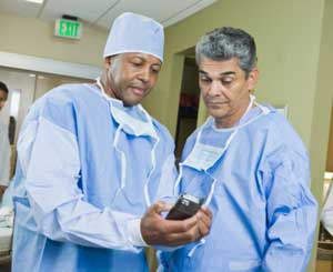 Image of surgeons examining a hand-held medical device.