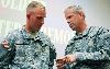 Brig. Gen. Donald MacWillie, senior commander, Fort Riley, right, explains the meaning of the 1st Inf. Div. coin to Pfc. Christopher Leheney, 4th Sqdn., 4th Cav. Regt., 1st ABCT, left, during an Oct. 26 ceremony at Fort Riley, in which Leheney was named the division’s Soldier of the Quarter.  Photo by: Amanda Kim Stairrett, 1ST INF. DIV.