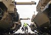 A contractor from Fort Hood, Texas, steps off a rail car after finishing unchaining two M1 tanks during offload Dec. 7 at Camp Funston. Photo by: Julie Fiedler, POST.