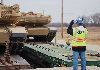 Helterbrand directs a driver as he offloads an M1 tank from a rail car Dec. 7 in Camp Funston.  Photo by: Julie Fiedler, POST.