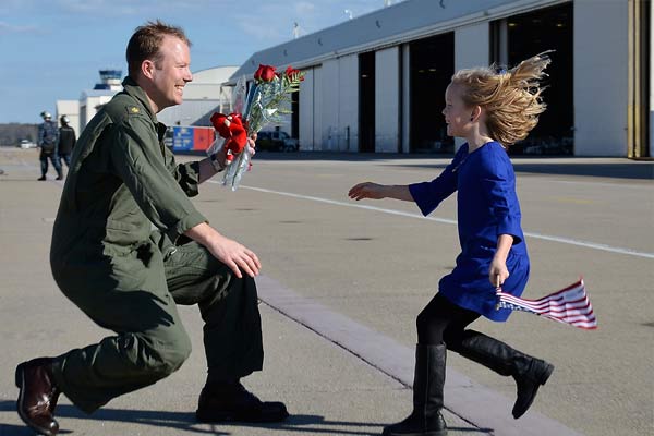 Lt. Cmdr. Pat Hart, assigned to Strike Fighter Squadron (VFA) 143, is reunited with his daughter during a homecoming celebration for the squadron. VFA-143, part of Carrier Air Wing (CVW) 7, returns to Naval Air Station Oceana after a six month deployment in the U.S. 5th and 6th Fleet areas of responsibility supporting Operation Enduring Freedom, maritime security operations and theater security cooperation efforts. (DoD photo by Mass Communication Specialist 2nd Class Antonio P. Turretto Ramos, U.S. Navy/Released).