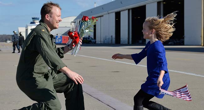 Lt. Cmdr. Pat Hart, assigned to Strike Fighter Squadron (VFA) 143, is reunited with his daughter during a homecoming celebration for the squadron. VFA-143, part of Carrier Air Wing (CVW) 7, returns to Naval Air Station Oceana after a six month deployment in the U.S. 5th and 6th Fleet areas of responsibility supporting Operation Enduring Freedom, maritime security operations and theater security cooperation efforts. (DoD photo by Mass Communication Specialist 2nd Class Antonio P. Turretto Ramos, U.S. Navy/Released).