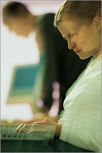 Photo of a woman working on a computer.