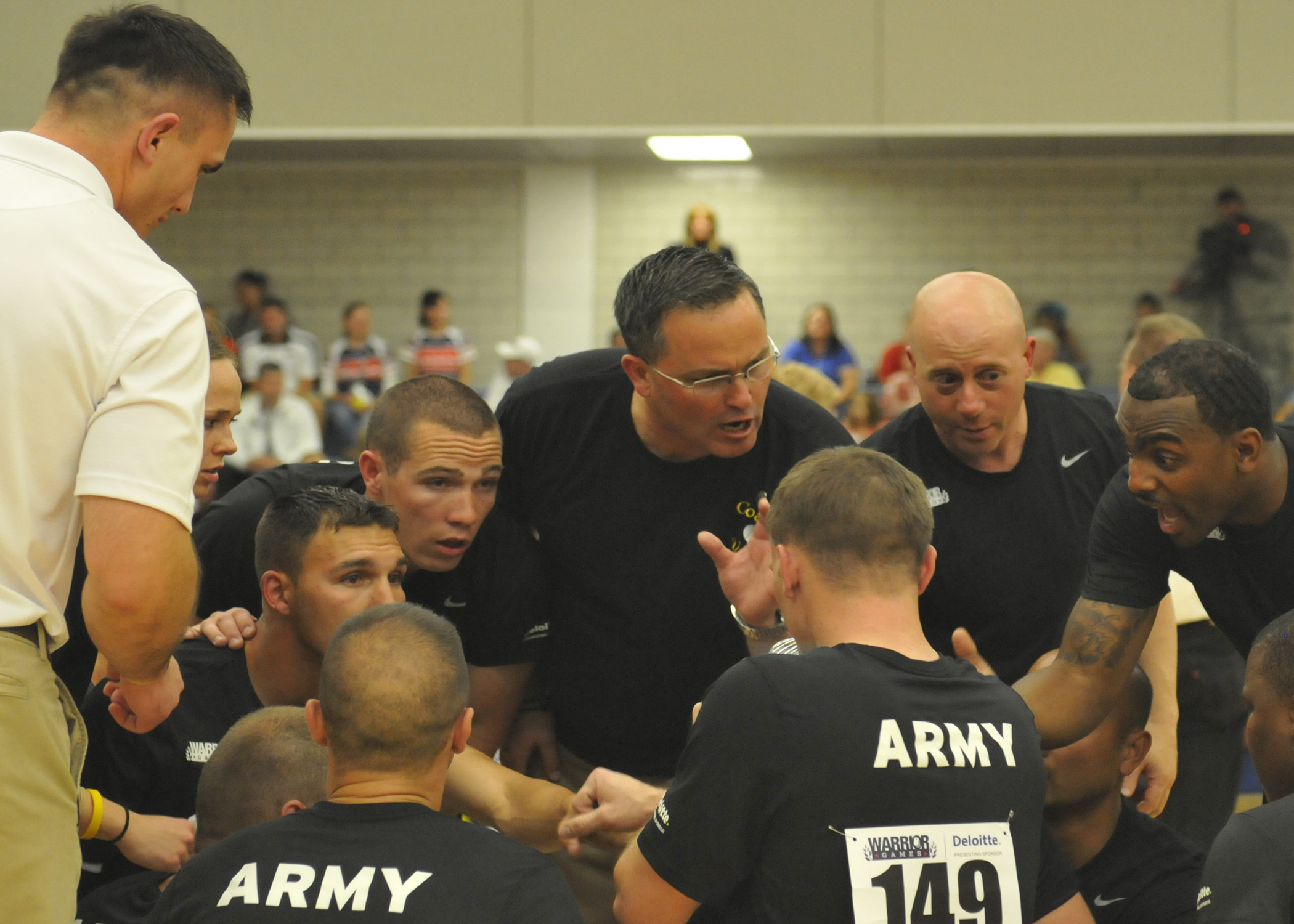 Army CPT David Vendt, U.S. Army sitting volleyball coach, pulls his team together to discuss strategy during the first set against the U.S. Navy at the 2012 Warrior Games on May 1, 2012 in Colorado Springs, Colorado.