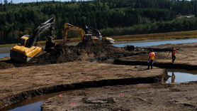 Large earth moving vehicles involved in restoration project