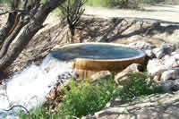 Water discharging from a large diameter vertical pipe.