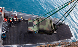 INDIAN OCEAN - Civilian mariners aboard the USNS Lewis and Clark (T-AKE-1) load a Marine Corps High Mobility Multipurpose Wheeled Vehicle (HMMWV) onto a ferryboat here Oct. 1. The ship is the newest edition to the Maritime Prepositioning Force and is currently testing its logistical capabilities. The MPF program is a combined Navy and Marine Corps effort, helping Marines fulfill their role and responsibility as the nation's force-in-readiness.